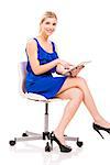 Beautiful woman sitting on a chair working with a tablet, isolated over white background