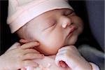 Sleeping newborn baby. The first days of life of the newborn girl