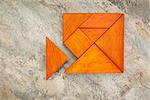 misfit concept - traingular piece is too large to fit into tangram square puzzle