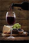Red wine with Cheese variety.Food background.  Fresh snacks on wood