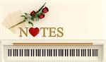 Top view of an upright piano with red roses,music sheet and three dimensional golden text and an heart - 3D Rendering