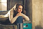 Portrait of thoughtful young woman in loft apartment