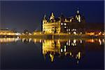 Schwerin Castle reflected in lake at night, Schwerin, Western Pomerania, Germany