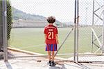 Boy Standing in front of Football Stadium, Valldemossa, Majorca, Spain