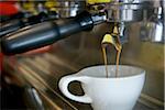 Double Shot of Espresso Pouring into White Cup