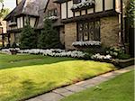 View of house exterior and front garden in summer, Toronto, Ontario, Canada