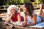 Mother and daughter on picnic blanket by the Blue Pool, Wareham, Dorset, United Kingdom