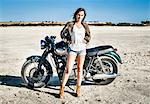 Portrait of female motorcyclist on arid plain, Cagliari, Sardinia, Italy