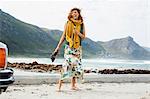 Young woman laughing on beach, Cape Town, Western Cape, South Africa