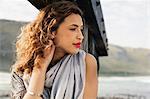 Young woman daydreaming on coastal pier, Cape Town, Western Cape, South Africa