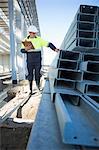 Site manager checking girders on construction site