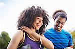 Young soccer couple laughing together in park