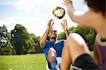 Young couple training with soccer ball in park