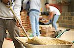 Cropped shot of three male college students in bricklaying workshop