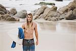 Australian surfer with surfboard, Bacocho, Puerto Escondido, Mexico