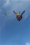 Team of two female skydivers in head down position over Buttwil, Luzern, Switzerland