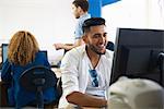 College students using personal computers in classroom