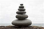Six coastal stones balanced on top of each other