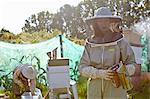 Female beekeepers working on city allotment