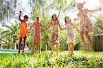 Five girls energetic girls jumping in garden