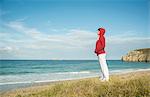 Mature woman gazing at sea view, Camaret-sur-mer, Brittany, France