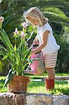 Girl watering garden plant