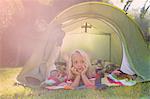 Portrait of girl lying gazing from garden tent