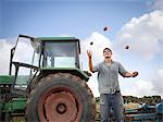 Farmer juggling with freshly harvested organic potatoes
