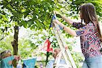 Grandparents and granddaughter hanging up bunting