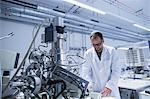 Lab assistant working on equipment