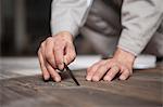 Carpenter checking quality of wood plank in factory, Jiangsu, China