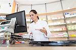 Pharmacist in pharmacy using computer