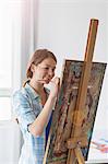 Female artist painting at easel