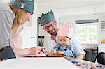 Parents with baby daughter wearing homemade crowns