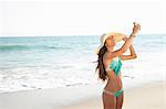 Young woman taking selfie on smartphone on beach, Malibu, California, USA