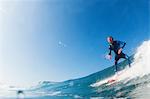 Mid adult man surfing, Leucadia, California, USA