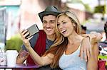 Couple taking selfie at cafe