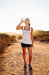 Female jogger drinking from water bottle, Poway, CA, USA