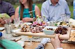 Family having meal together, outdoors