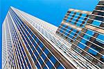 Low angled view of office buildings in financial district, Manhattan, New York, USA