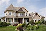 Beige with white trim cottage style house facade, Quebec, Canada