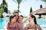 Family with two children enjoying themselves in swimming pool