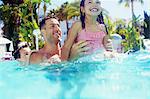 Father with daughter and son playing in swimming pool