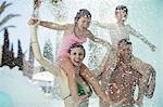 Family with two children enjoying themselves in swimming pool