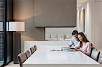 Couple using tablet pc in dining room