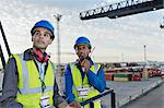 Workers standing on cargo crane