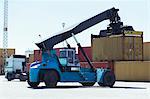 Crane lifting cargo container