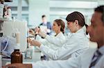 Scientist pipetting sample in laboratory