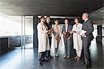 Scientists and business people talking in lobby