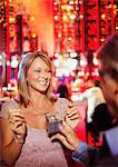 Man handing gift to woman in bar